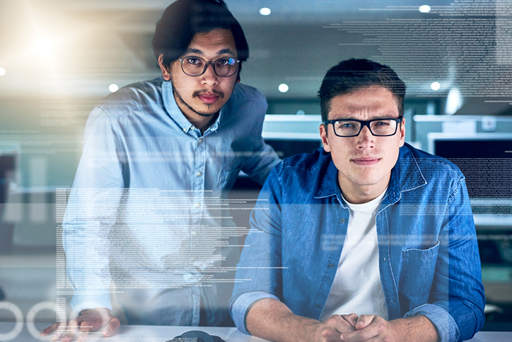 Two men looking at a data screen